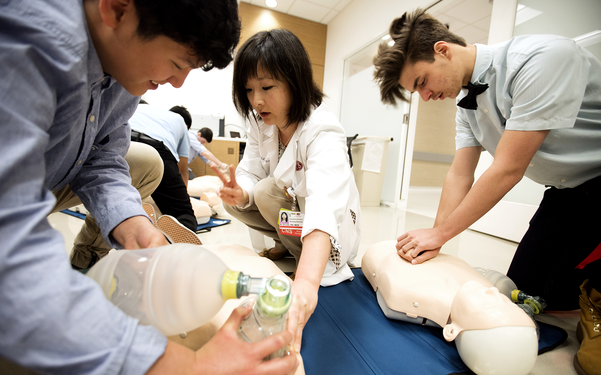 Registered nurse Ai Jin Lee shows students from Bravo Magnet High School how to perform CPR.