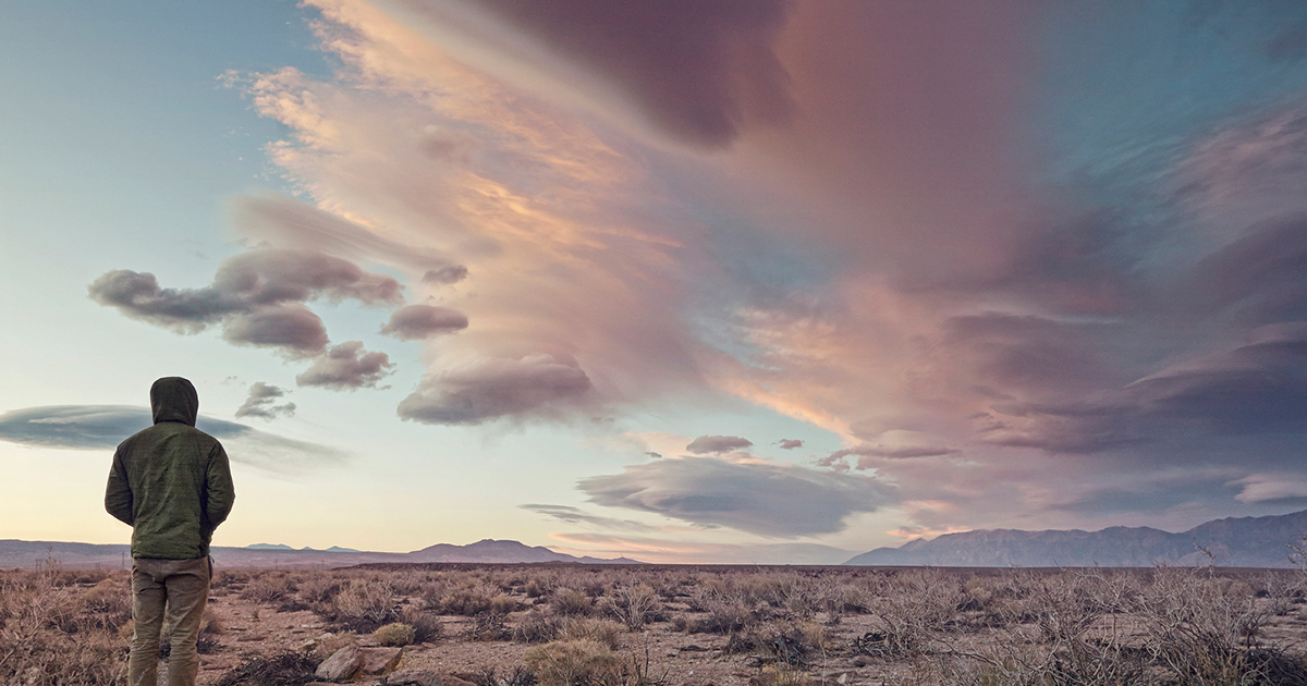 Man in desert with dramatic sky