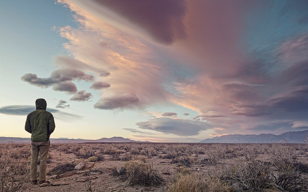 Man in desert with dramatic sky