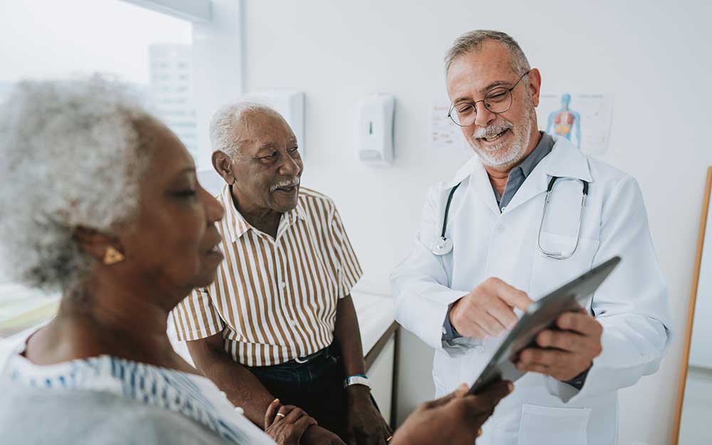 Doctor talking to an elderly couple.